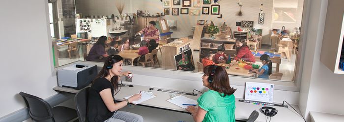 Early childhood interns observing a student classroom