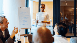 Professional woman leading soft skills training workshop presentation with whiteboard in modern office conference room